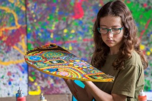 Girl with a final art work ready for exhibition
